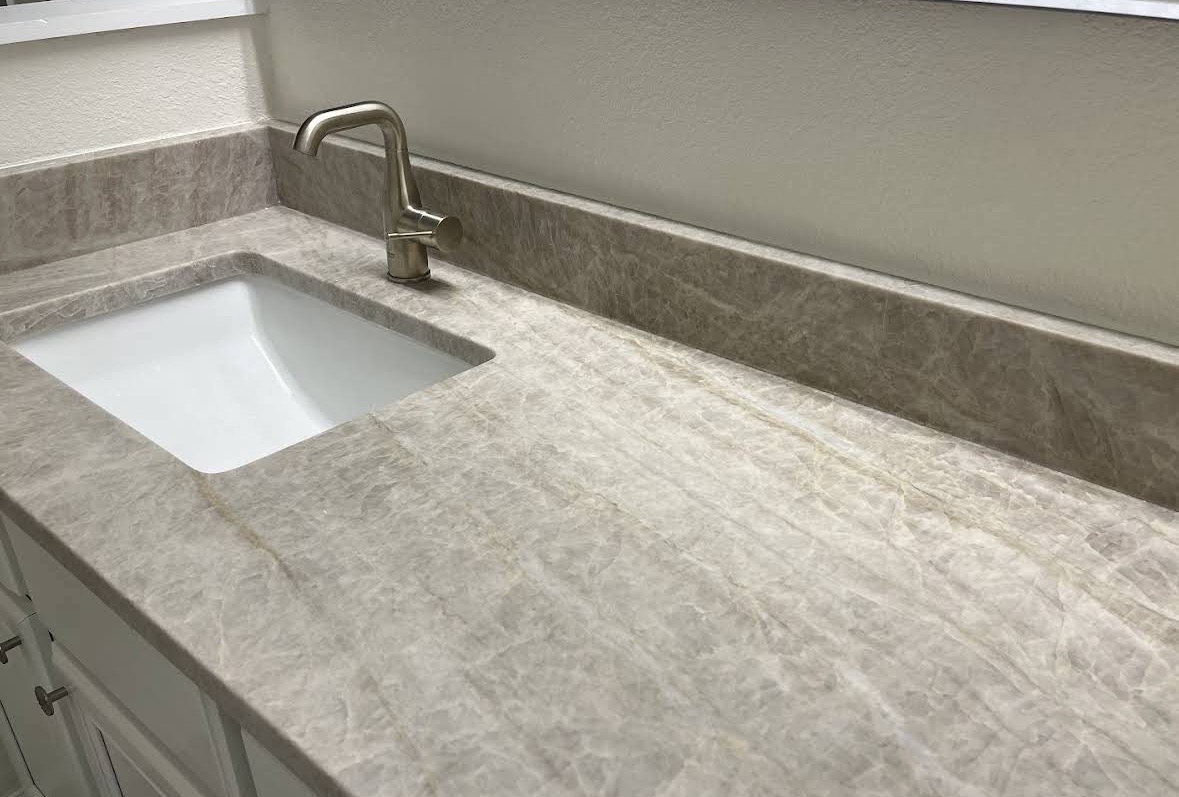 Taj Mahal quartzite bathroom vanity top with matching backsplash and undermount sink